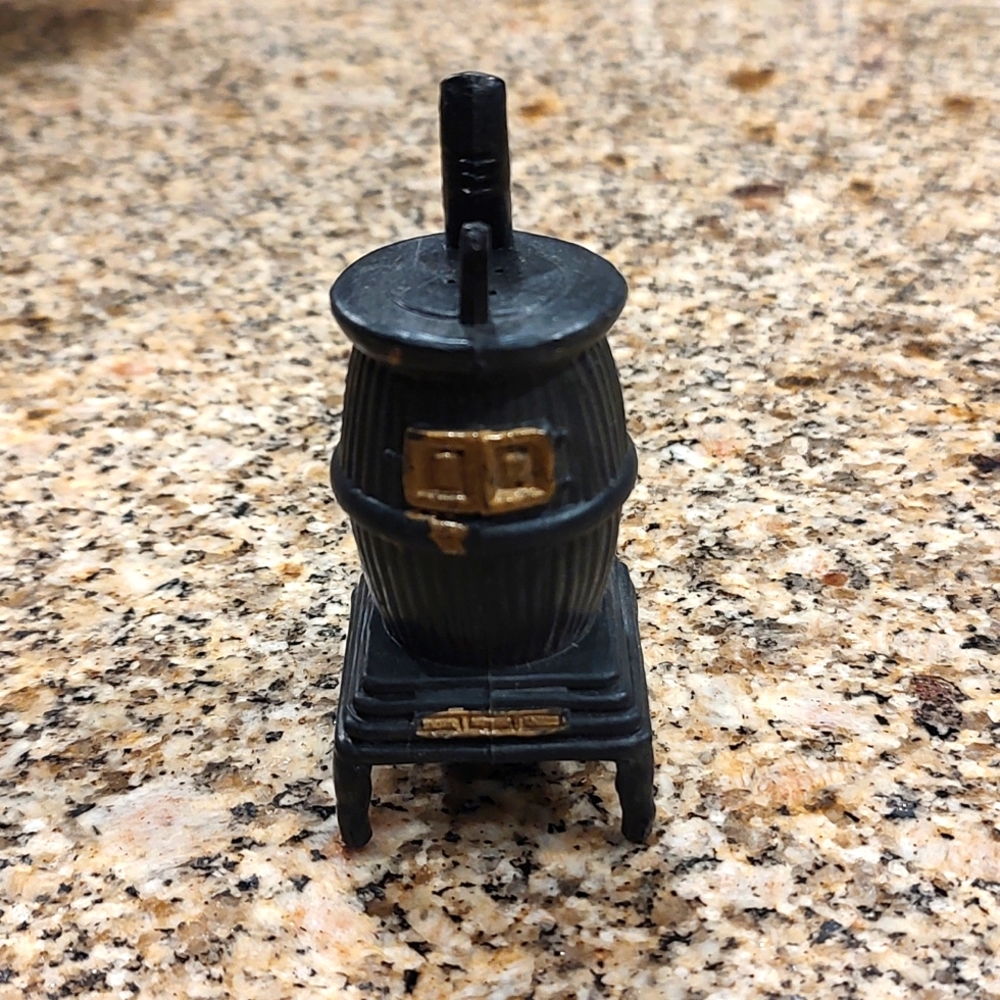Vintage plastic pot belly stove shaker.